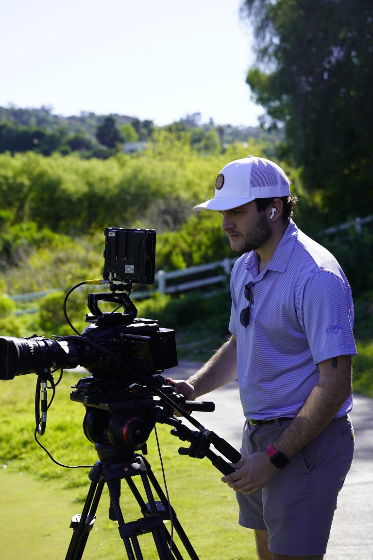 Camera operator filming on the course
